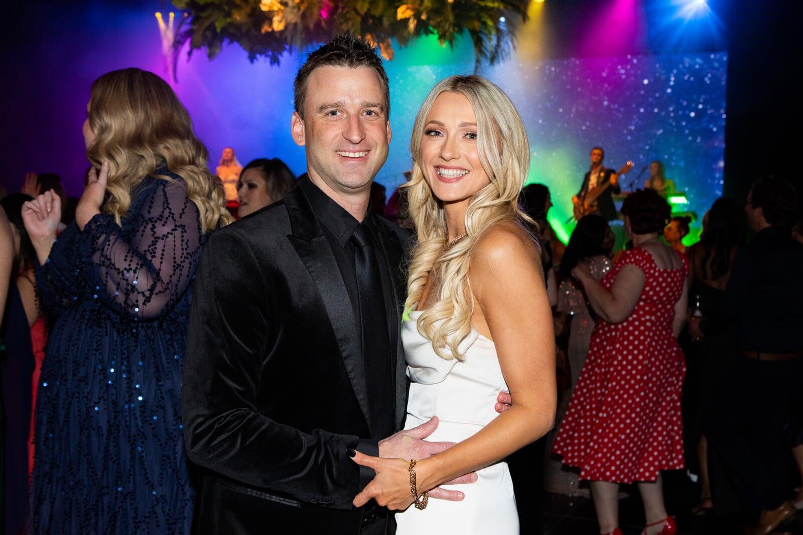 Corporate awards night event photography in Perth featuring gala guests celebrating under professional stage lighting.